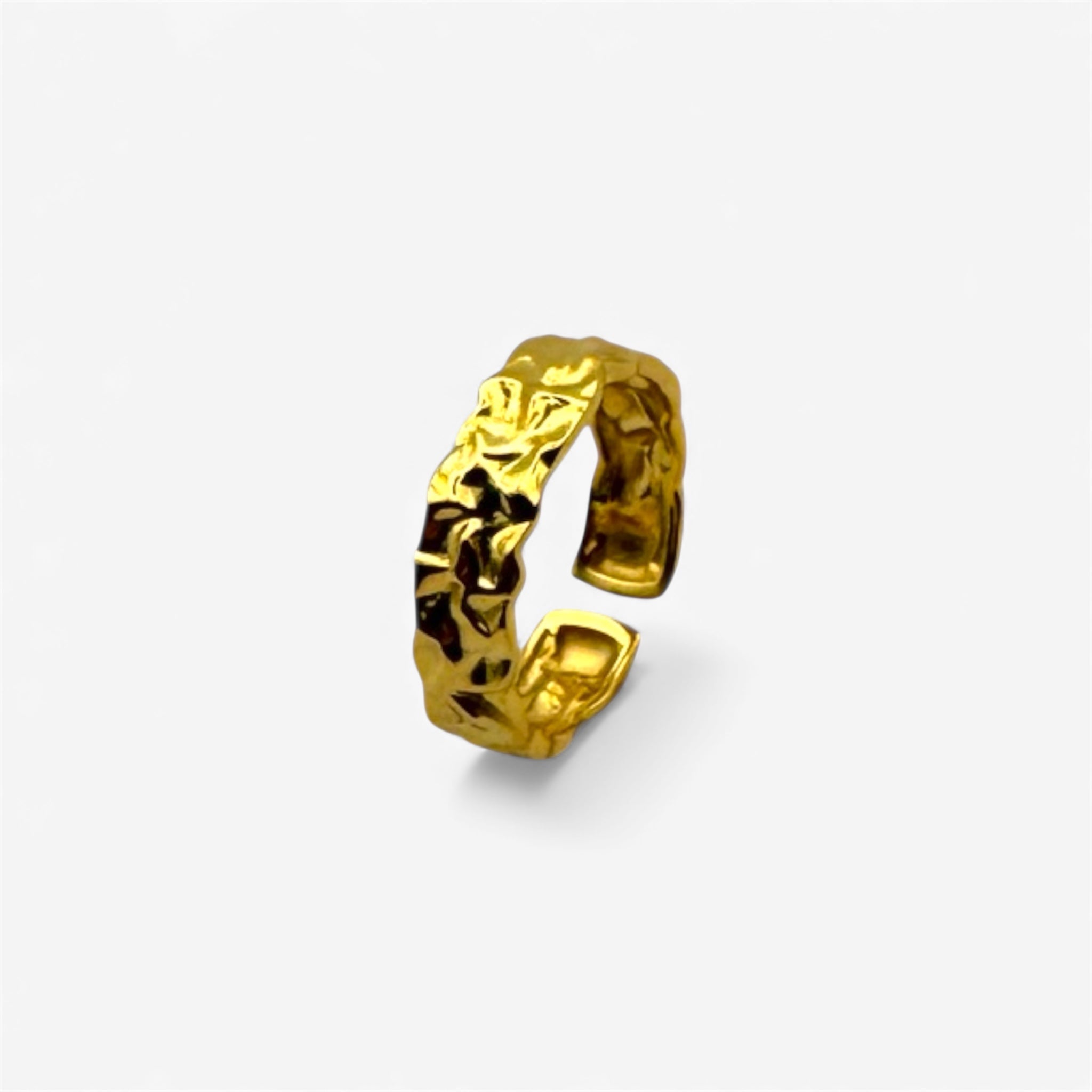 Textured gold open ring with crumpled design on a white background, minimalist jewelry