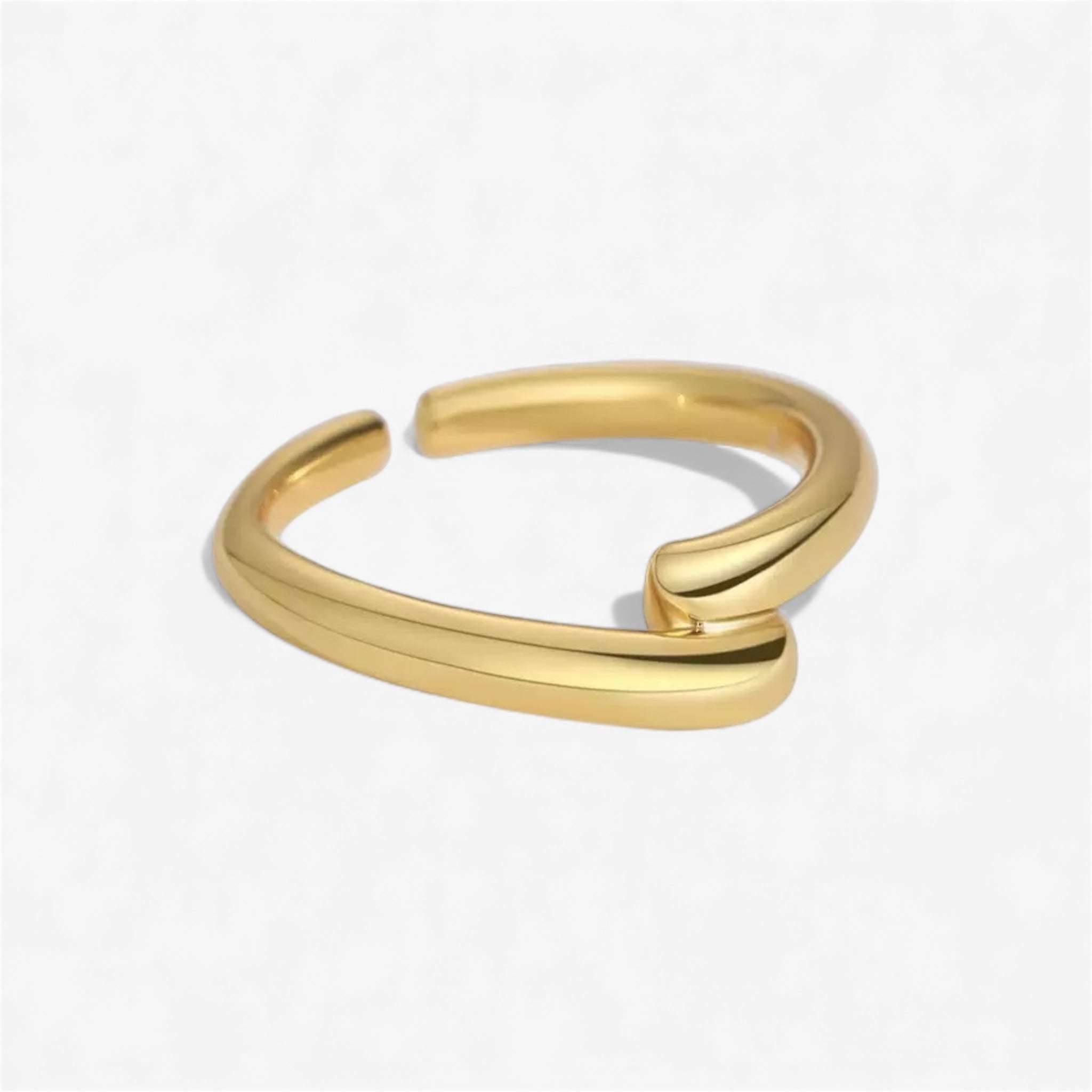 Minimalist gold open band ring with a modern, curved design on a white background