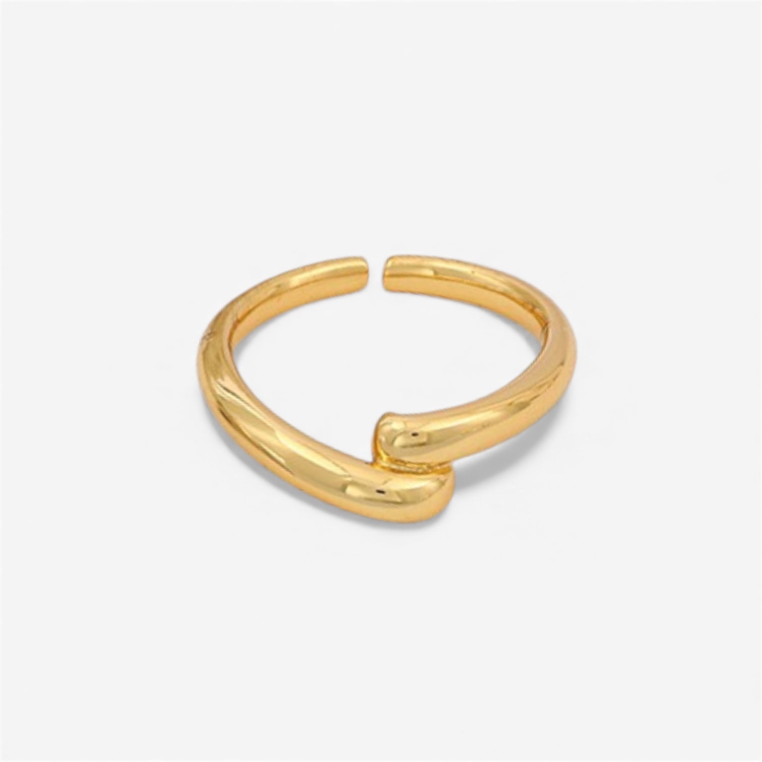 Minimalist open gold ring with a modern, chunky design on a white background