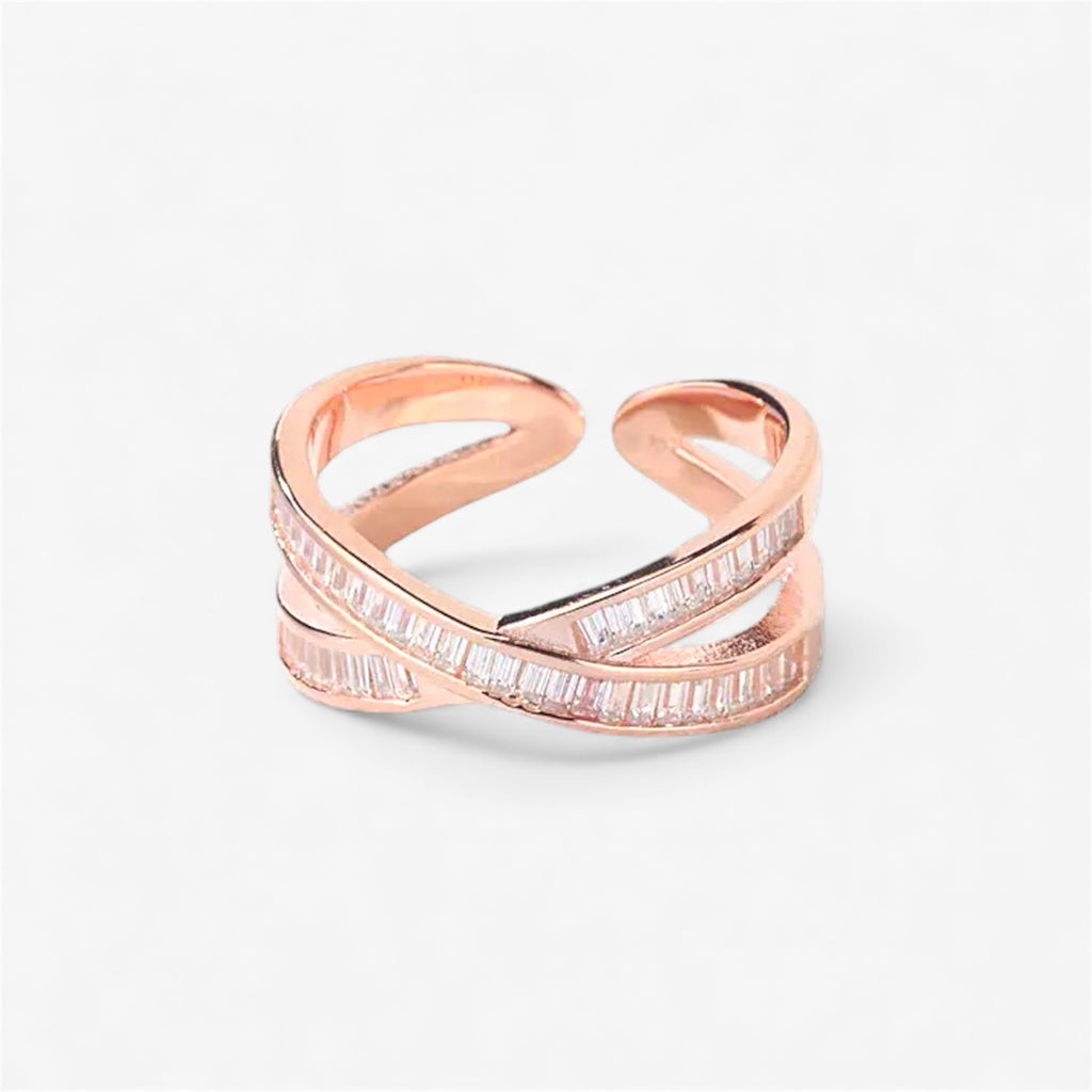 Rose gold open band ring with minimalist criss-cross design and baguette cut stones