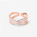 Rose gold open band ring with minimalist criss-cross design and baguette cut stones