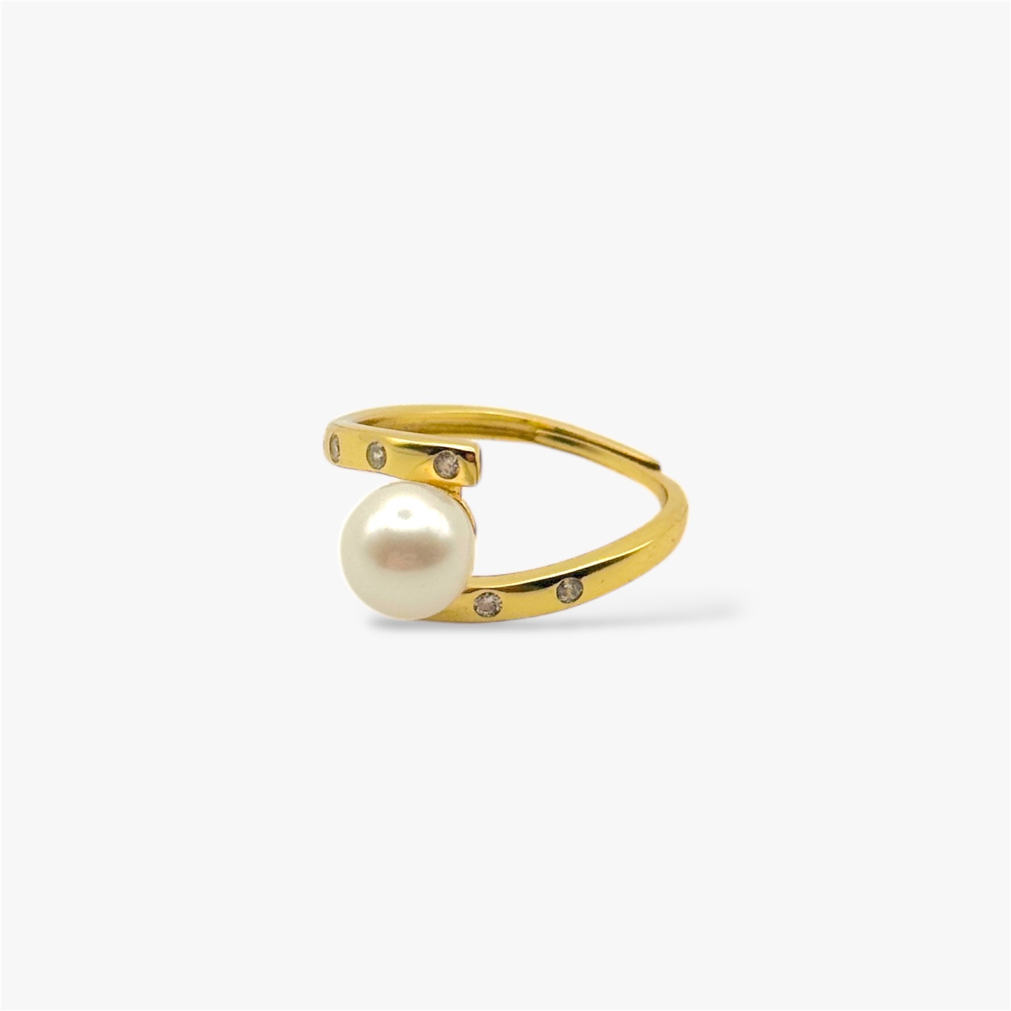 Gold minimalist ring with a central pearl and small gemstone accents on white background