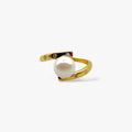 Gold wrap ring with central white pearl and small crystal accents on white background