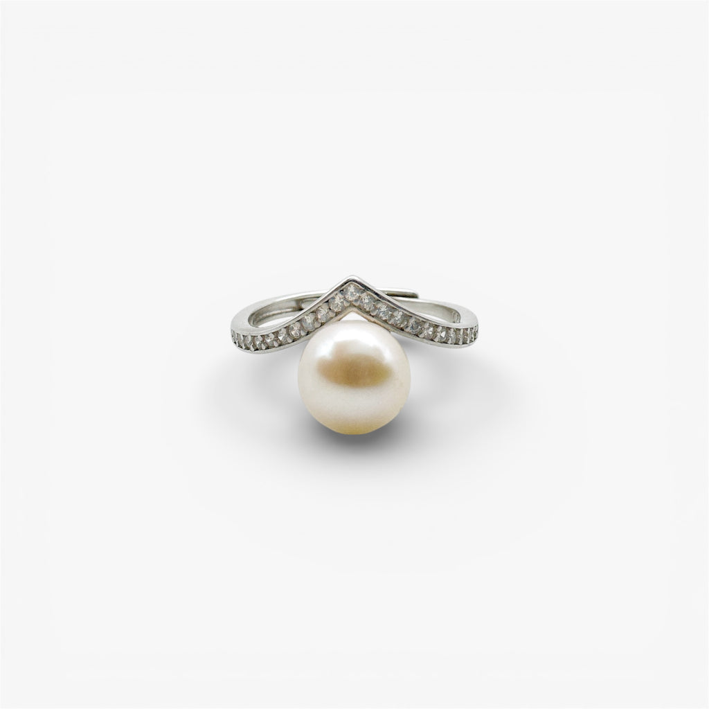 Modern silver ring with large pearl and pavé-set cubic zirconia on white background