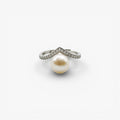 Modern silver ring with large pearl and pavé-set cubic zirconia on white background