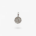 Textured silver round pendant with rope edge and small clear stones on white background