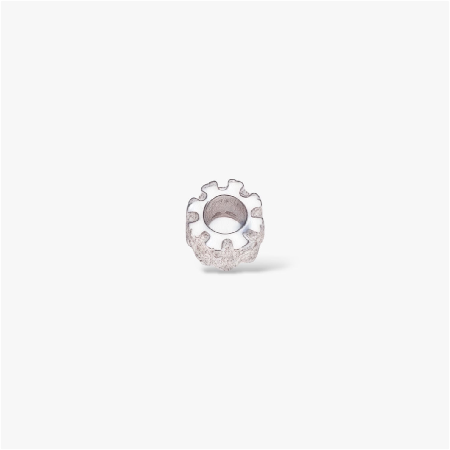Textured silver gear-shaped minimalist ring on a white background