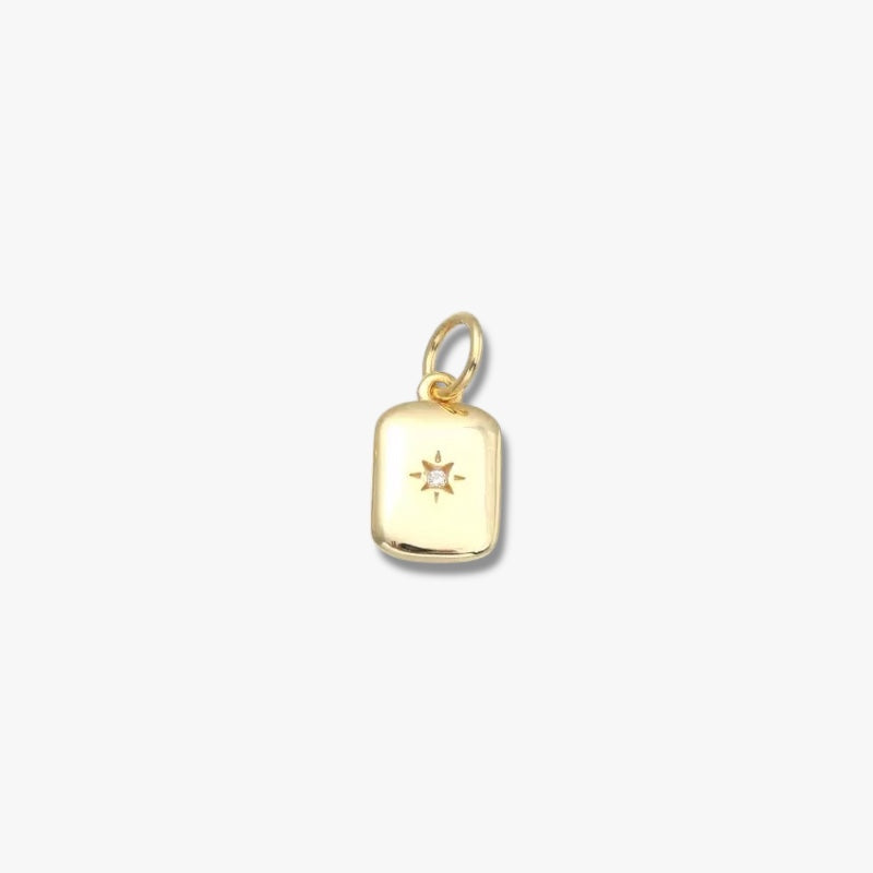Gold rectangular pendant charm with star design and central gemstone, minimalist jewelry