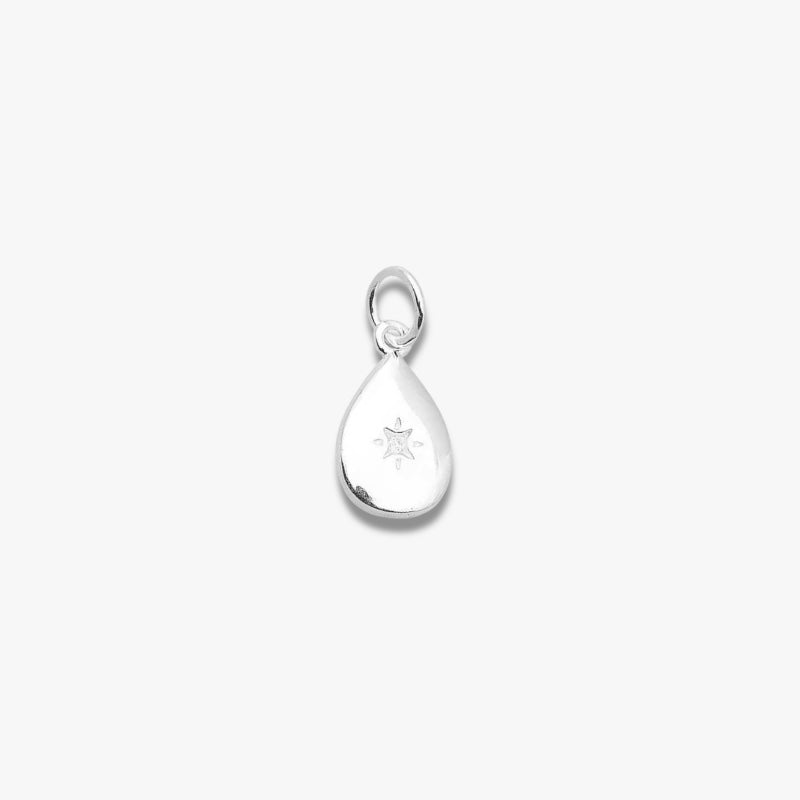 Minimalist teardrop silver pendant with engraved star detail on white background