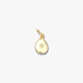 Gold teardrop pendant with engraved star design and small central gemstone on white background