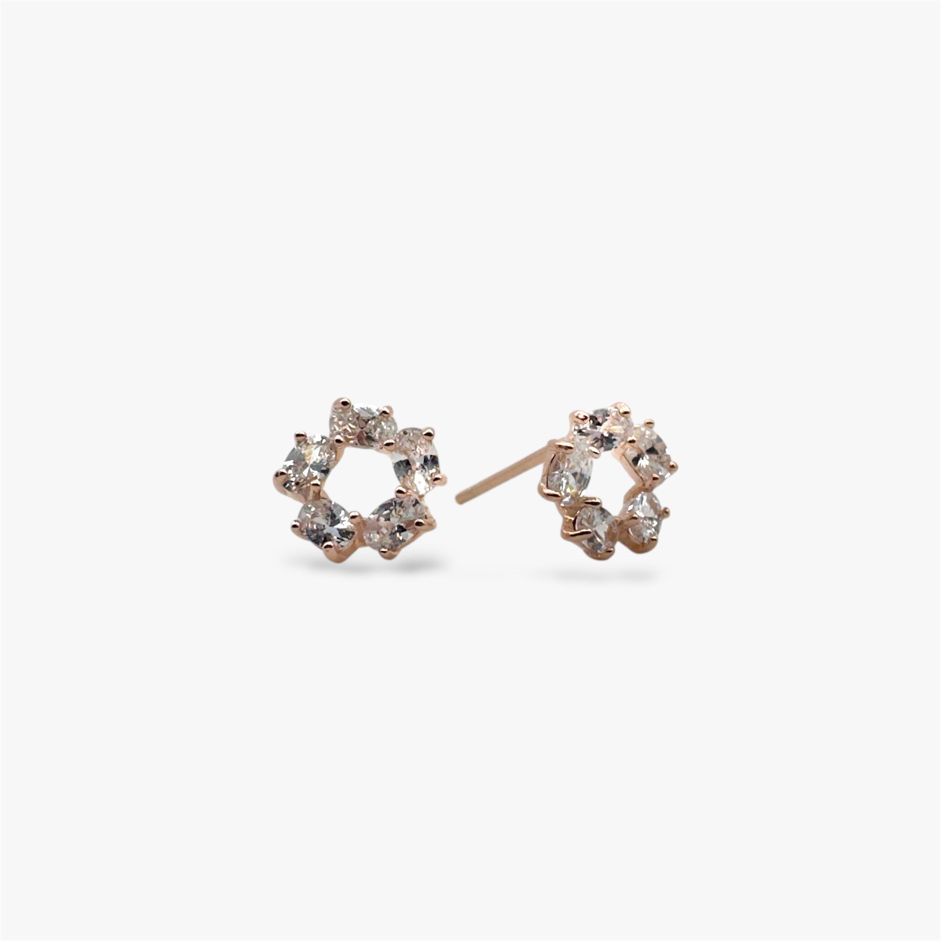Sparkly circular crystal stud earrings in rose gold.