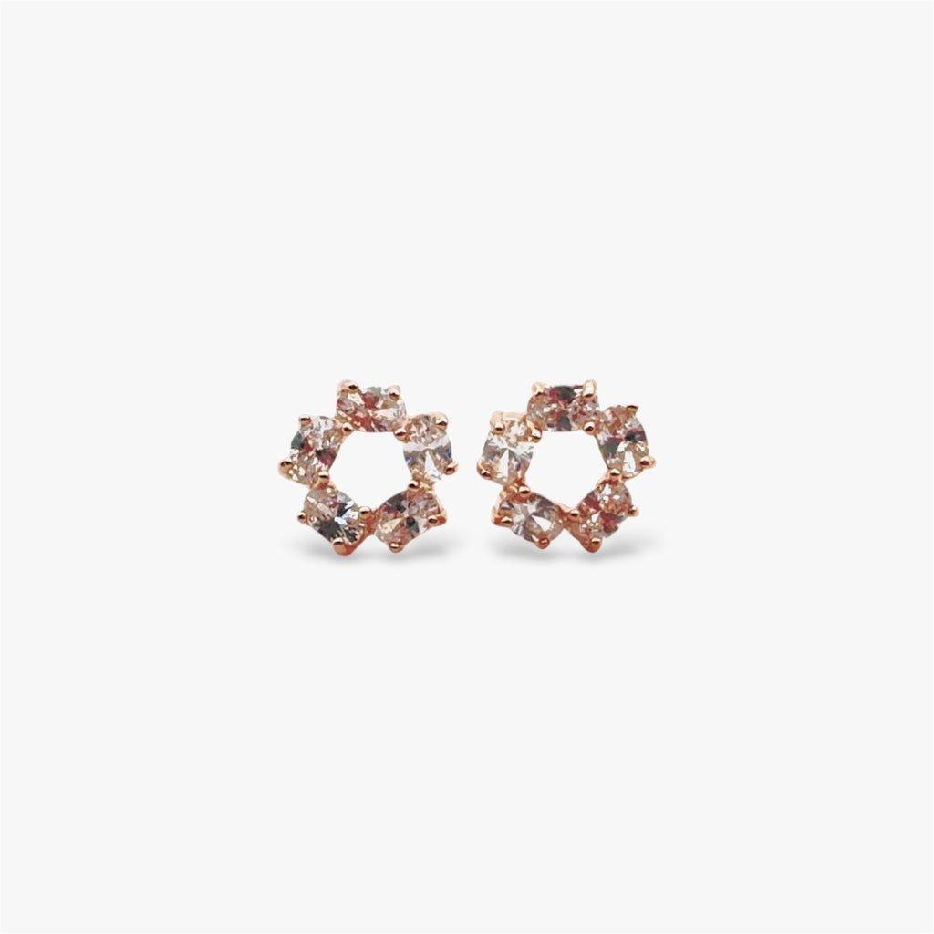 Sparkly circular crystal stud earrings in rose gold.