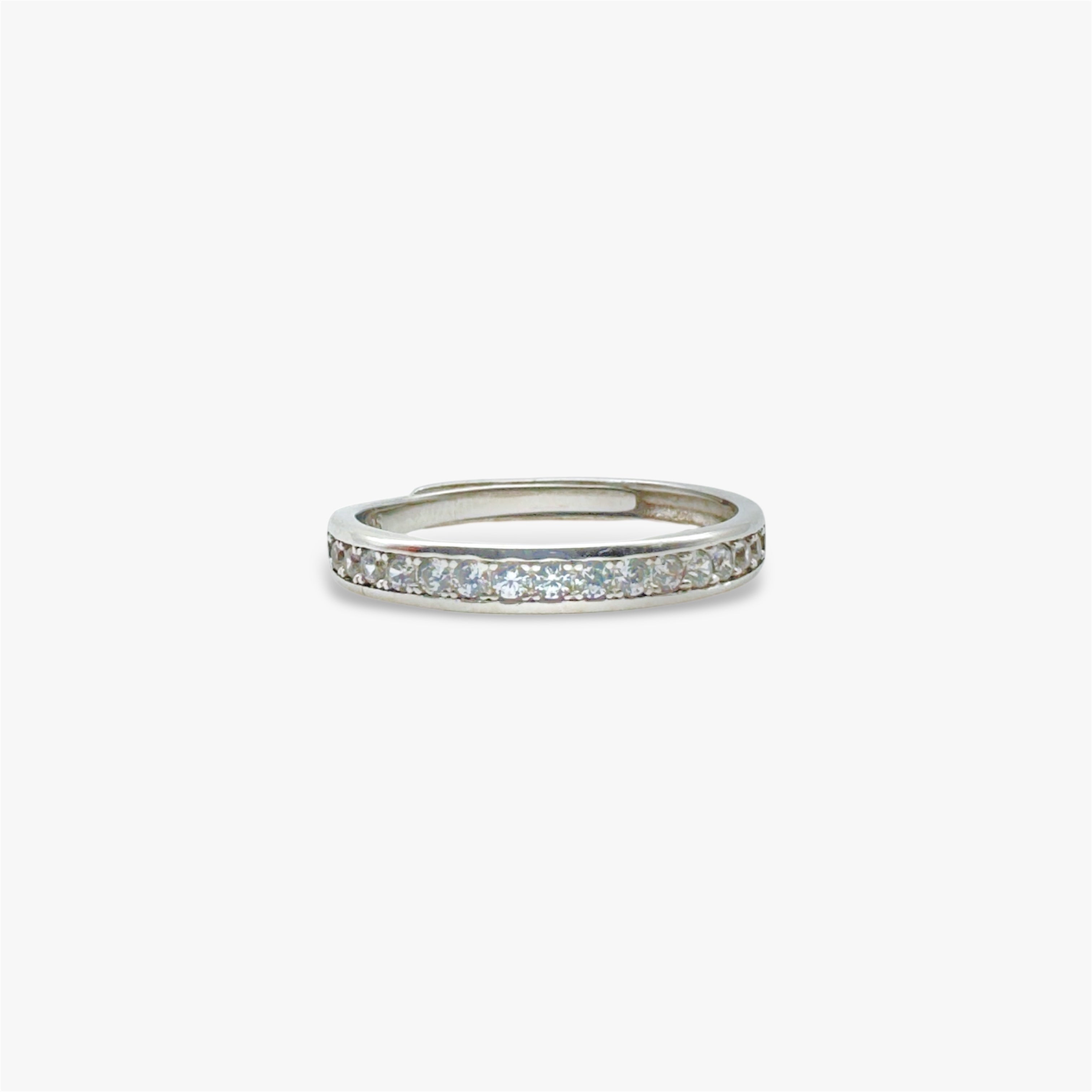 Silver eternity ring with embedded crystal stones.