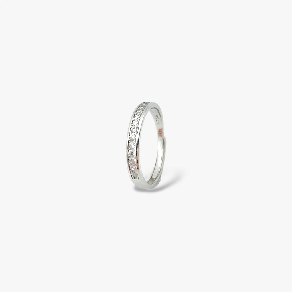 Silver eternity ring with embedded crystal stones at a sideways angle.