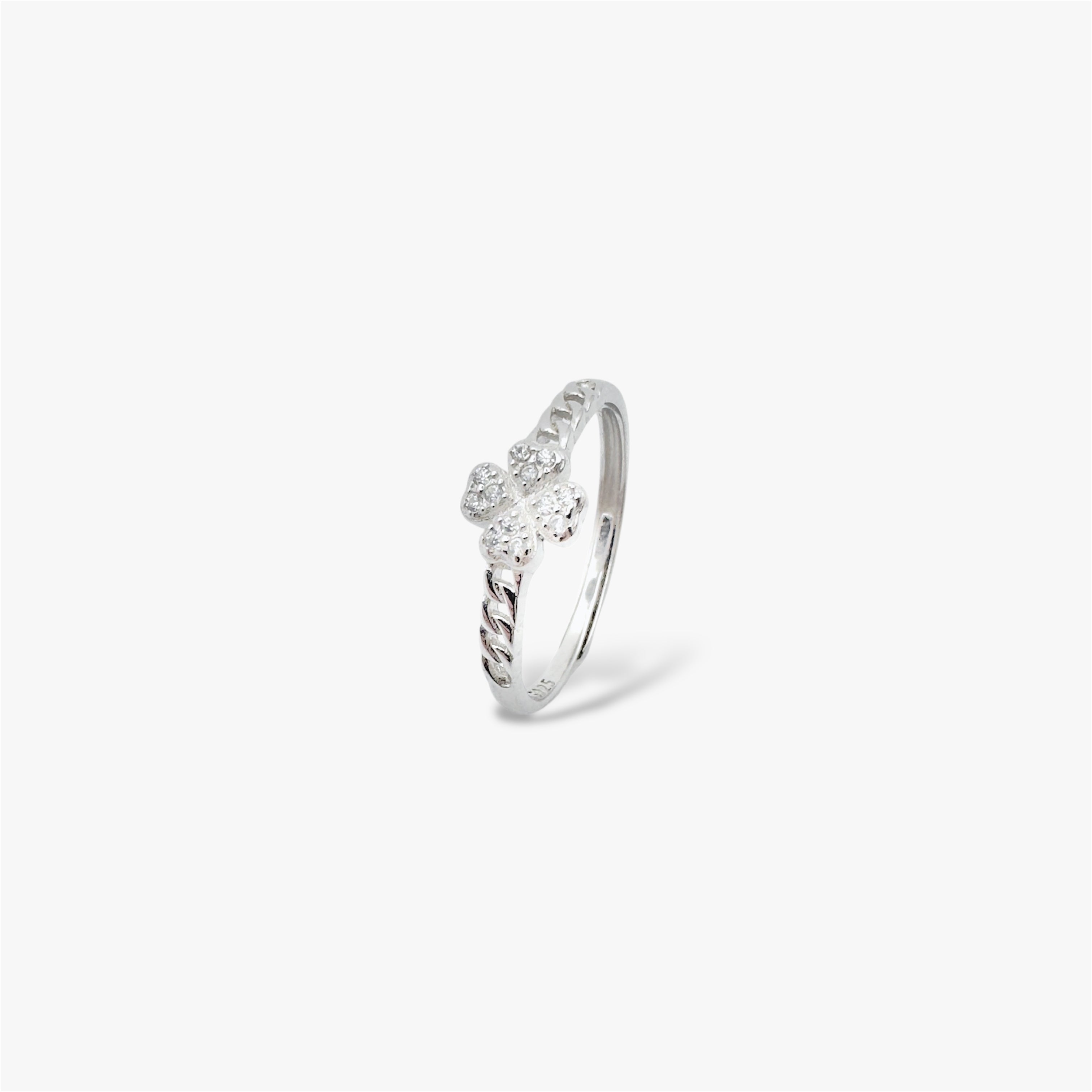 Four leaf clover silver ring with crystals at a sideways view.