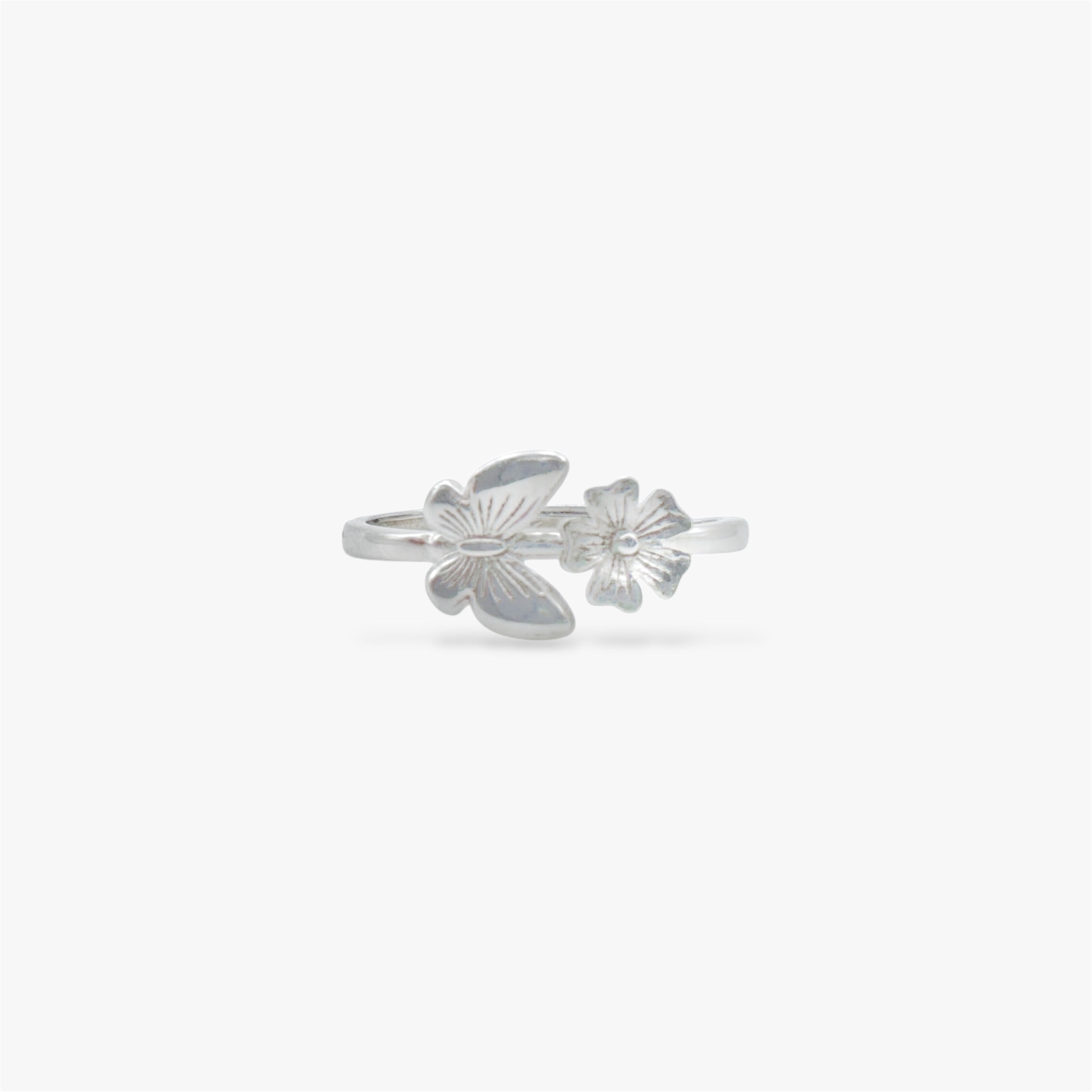 Silver ring with a floral design and a butterfly design.