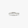 Silver ring with a heart design and crystals.