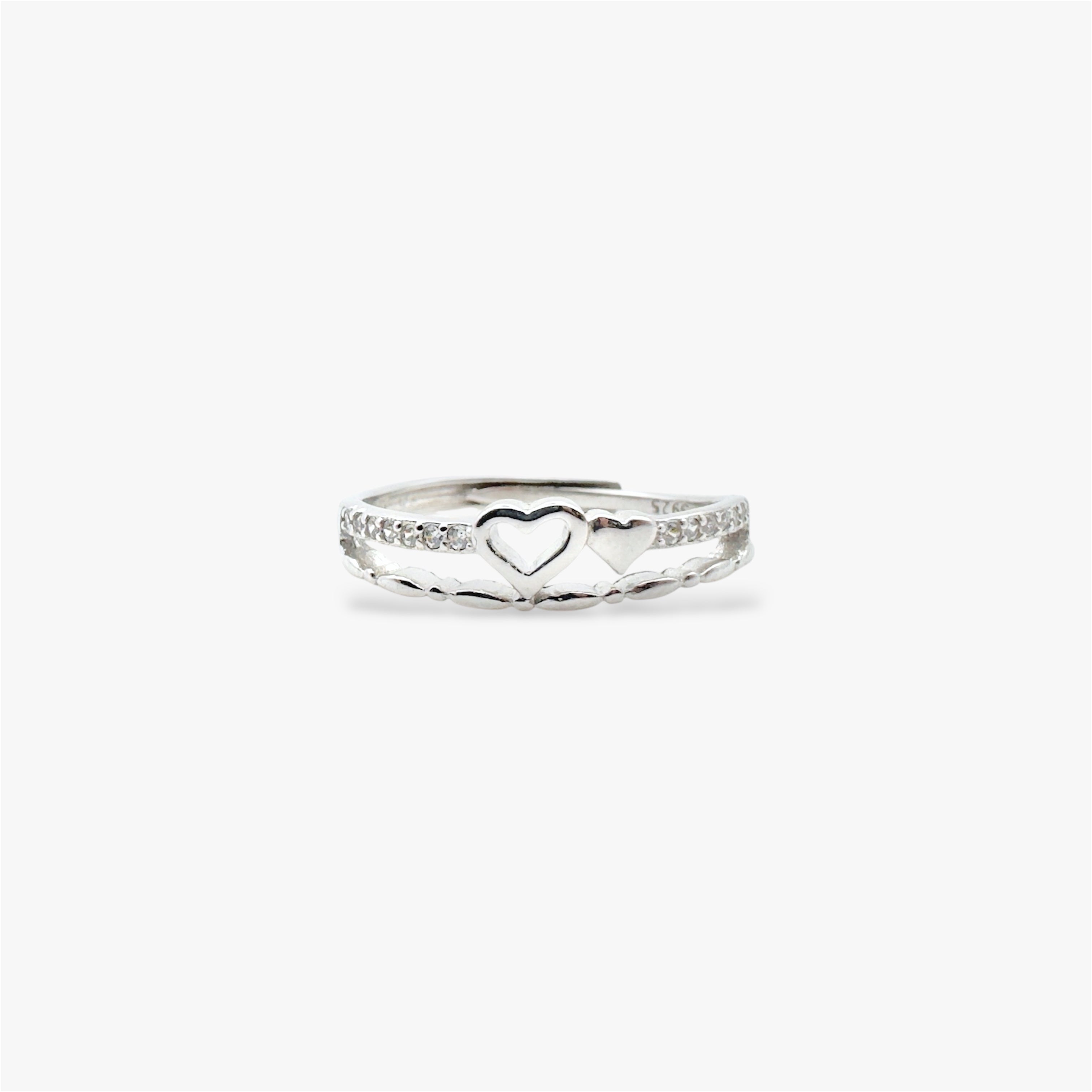 Silver ring with a heart design and crystals.