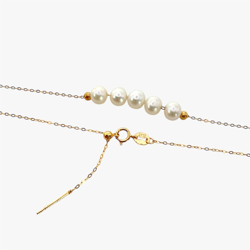 Close up of necklace with freshwater pearls in gold plated sterling silver.