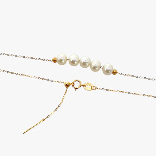 Close up of necklace with freshwater pearls in gold plated sterling silver.