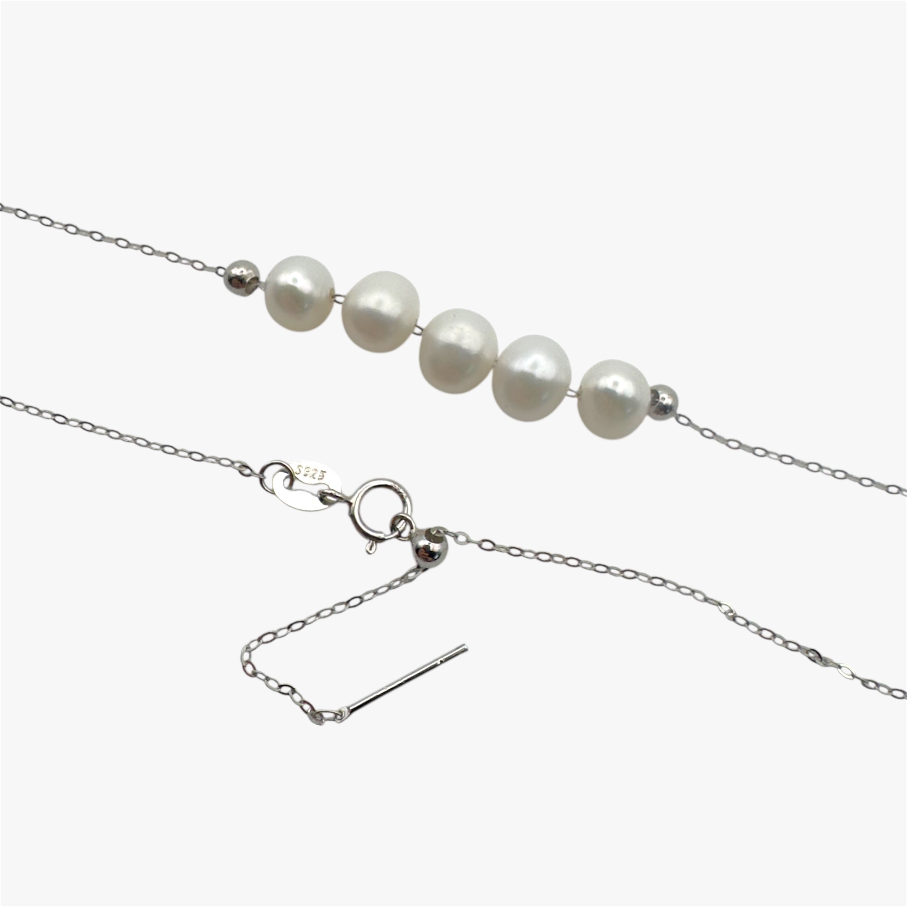 Close up of necklace with freshwater pearls in silver.