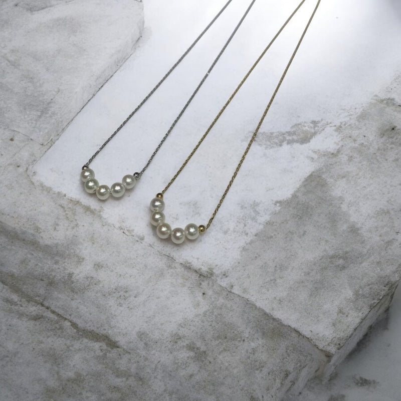 Verduri classic pearl necklaces on a marble surface.