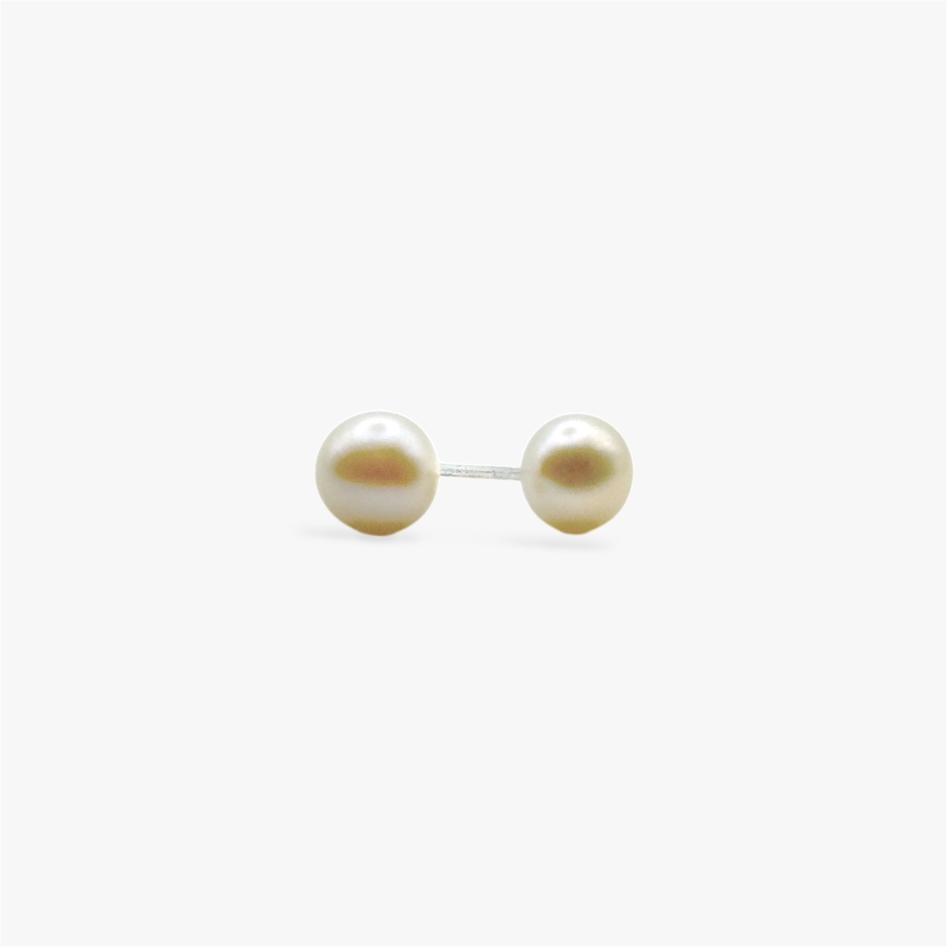 Close up of rhodium plated sterling silver pearl stud earrings with round freshwater pearls