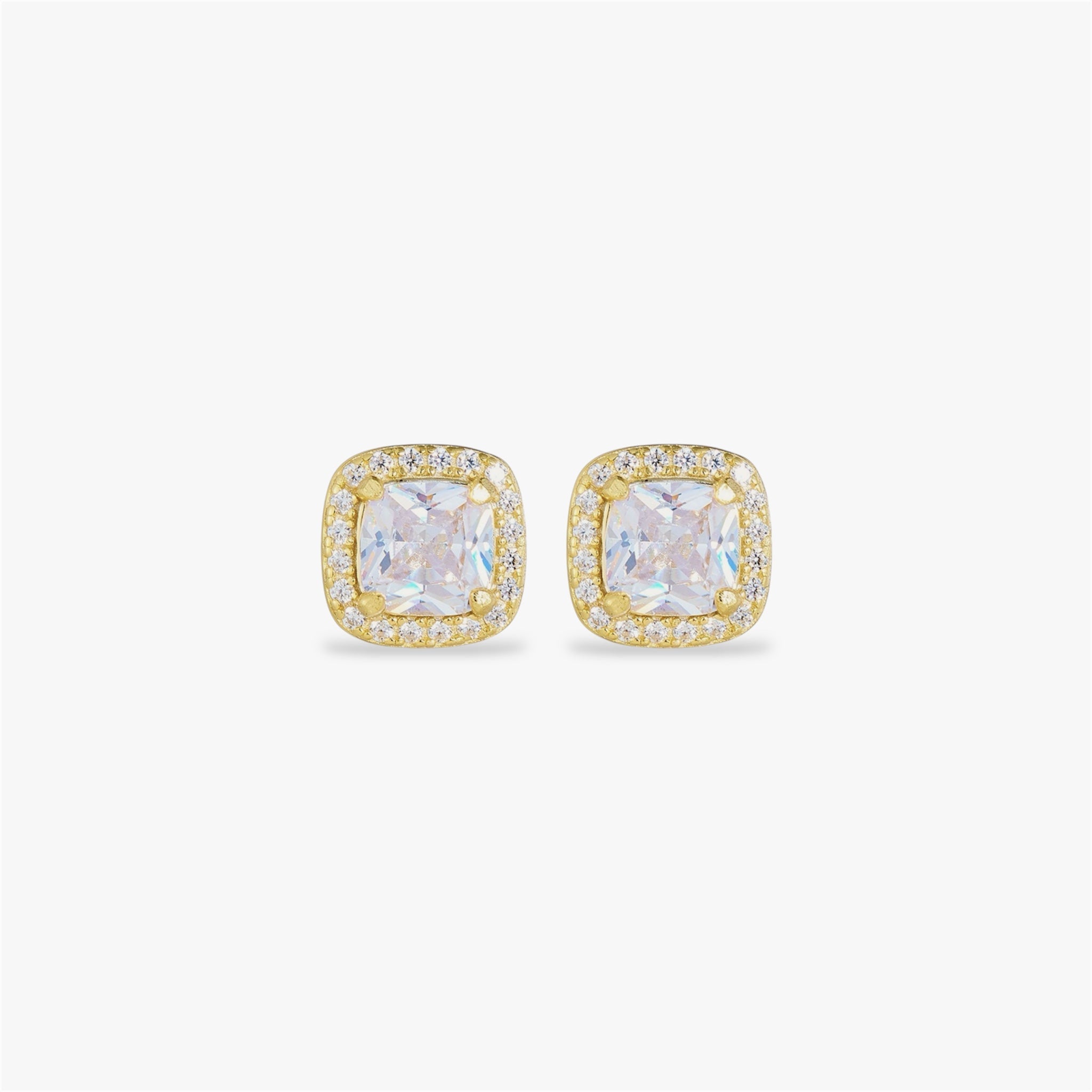Gold earrings with crystal gemstones on a white background