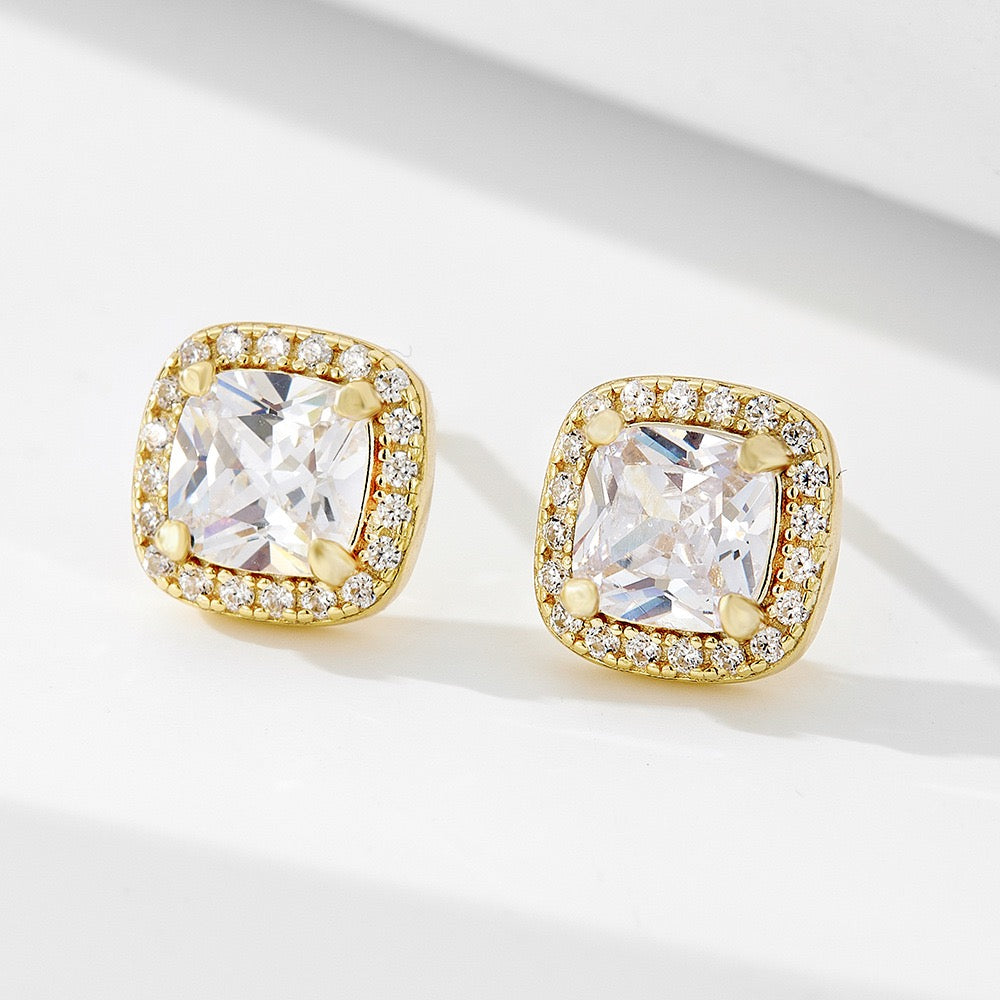 Gold square stud earrings with clear gemstone center and pavé crystal halo, minimalist style